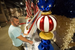 Float builders are transforming history into colorful, sequin-filled displays for the Semiquincentennial parade