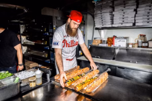 Brandon Marsh stars in the commercial for Victus’ new cheesesteak-themed bat. It was filmed at Angelo’s in just one take.